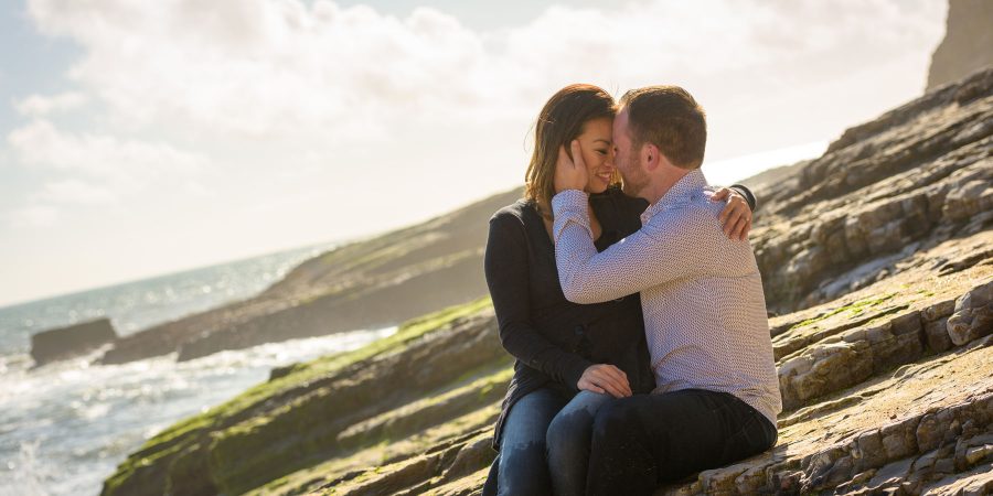 couple kissing as he caresses her cheek - Panther Beach Santa Cruz and Quail Hollow Felton engagement photography - Sara and Scott - photos by Bay Area wedding photographer Chris Schmauch