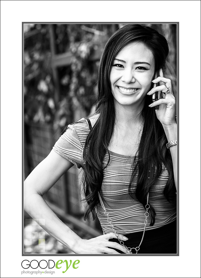 business portrait of attractive asian woman walking outside talking on her phone